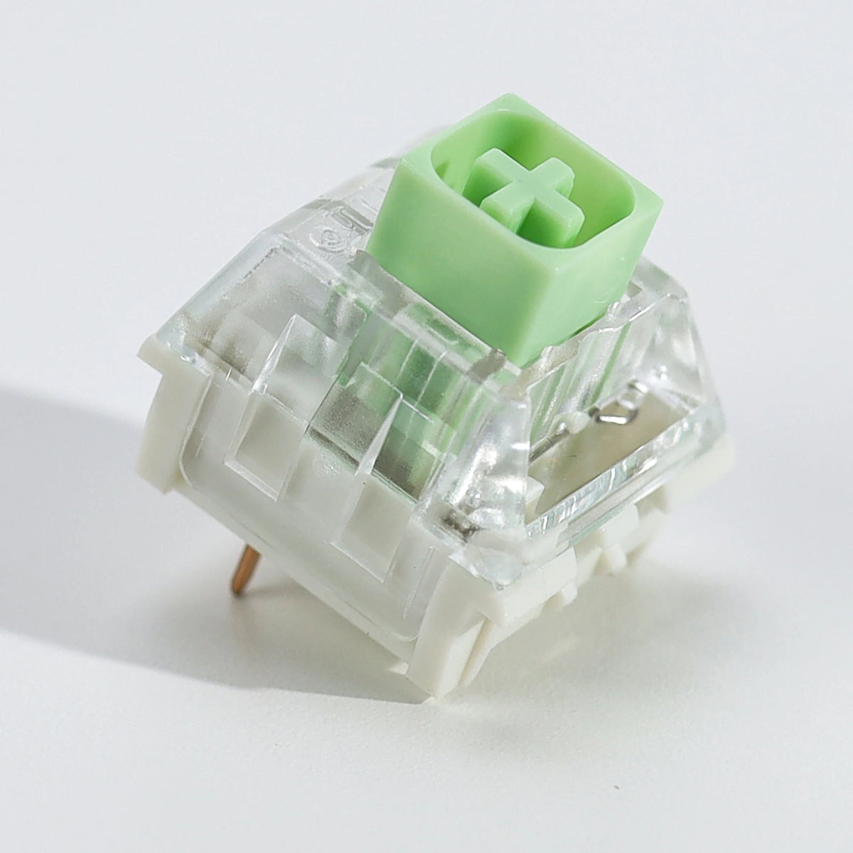 A close-up view of a light green tactile clicky mechanical keyboard switch housing.