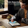 A woman is using a precision stylus pen on an iPad, demonstrating palm rejection technology.