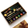 A luxury fountain pen set with a wax seal kit displayed in a wooden box.