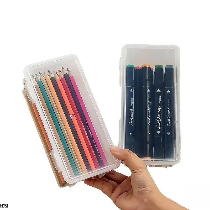 A hand holds a clear storage box filled with black pens and markers.