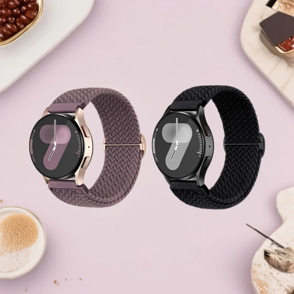A close-up of a purple braided loop watch band and a black silicone strap for Garmin devices.