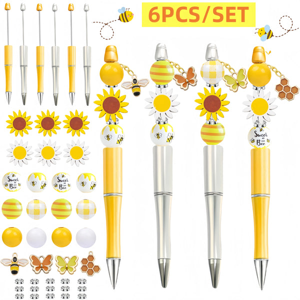 A set of six beaded pens featuring a sunflower theme with yellow and gold accents.