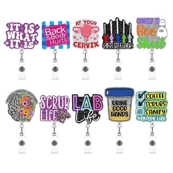 A collection of acrylic badge reels featuring various sayings and designs like Back & Body Hurts, Cancer is Boo Sheet, and La