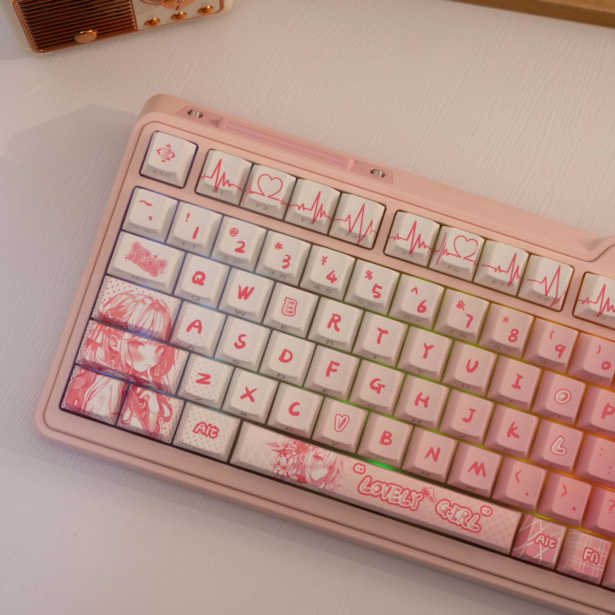A close-up of a pink mechanical keyboard featuring PBT side-printed translucent keycaps with heart and ECG graphics.