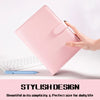A pink A5 PU leather binder notebook with a cover flap is held by a hand next to a white keyboard and blue pen.