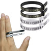 A hand holds several black and white reusable ring sizer measuring tools for accurate finger sizing.