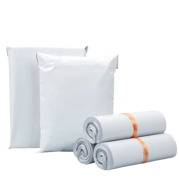 White self-sealing plastic mailing bags shown in various sizes and rolled up