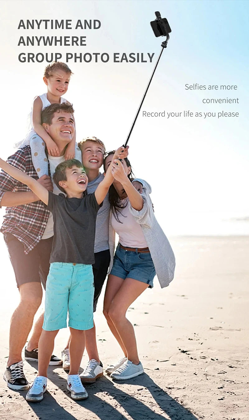 A group of diverse young people taking a selfie outdoors using a Bluetooth selfie stick.