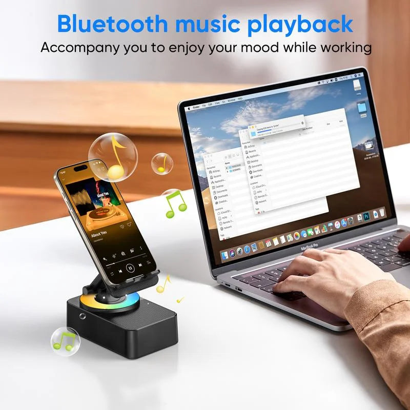 A laptop is shown next to a smartphone mounted on a wireless speaker stand, playing Bluetooth music for working.