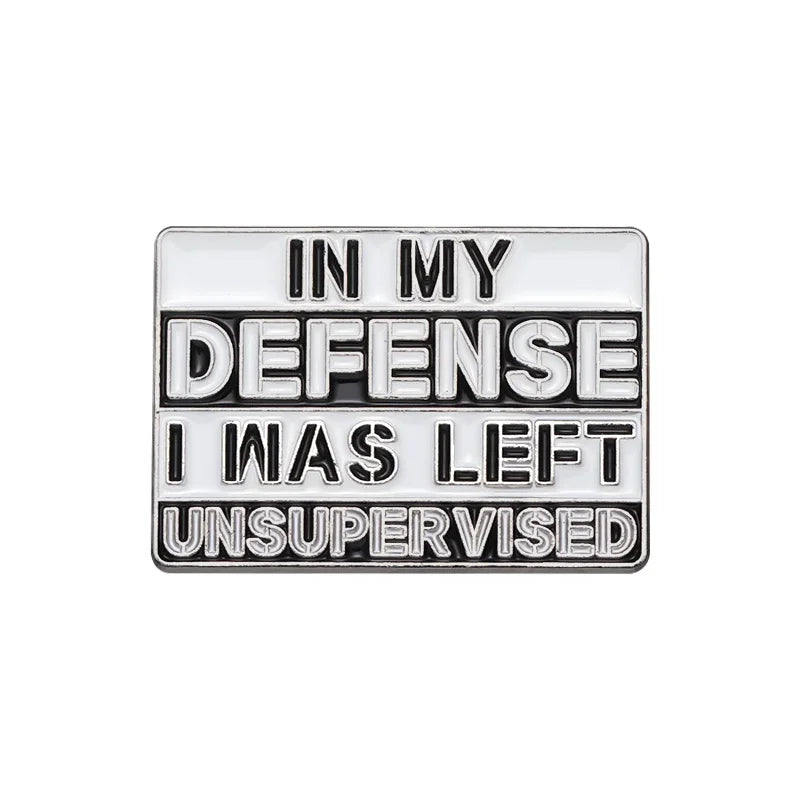 Silver enamel pin with the text In My Defense I Was Left Unsupervised engraved on it.