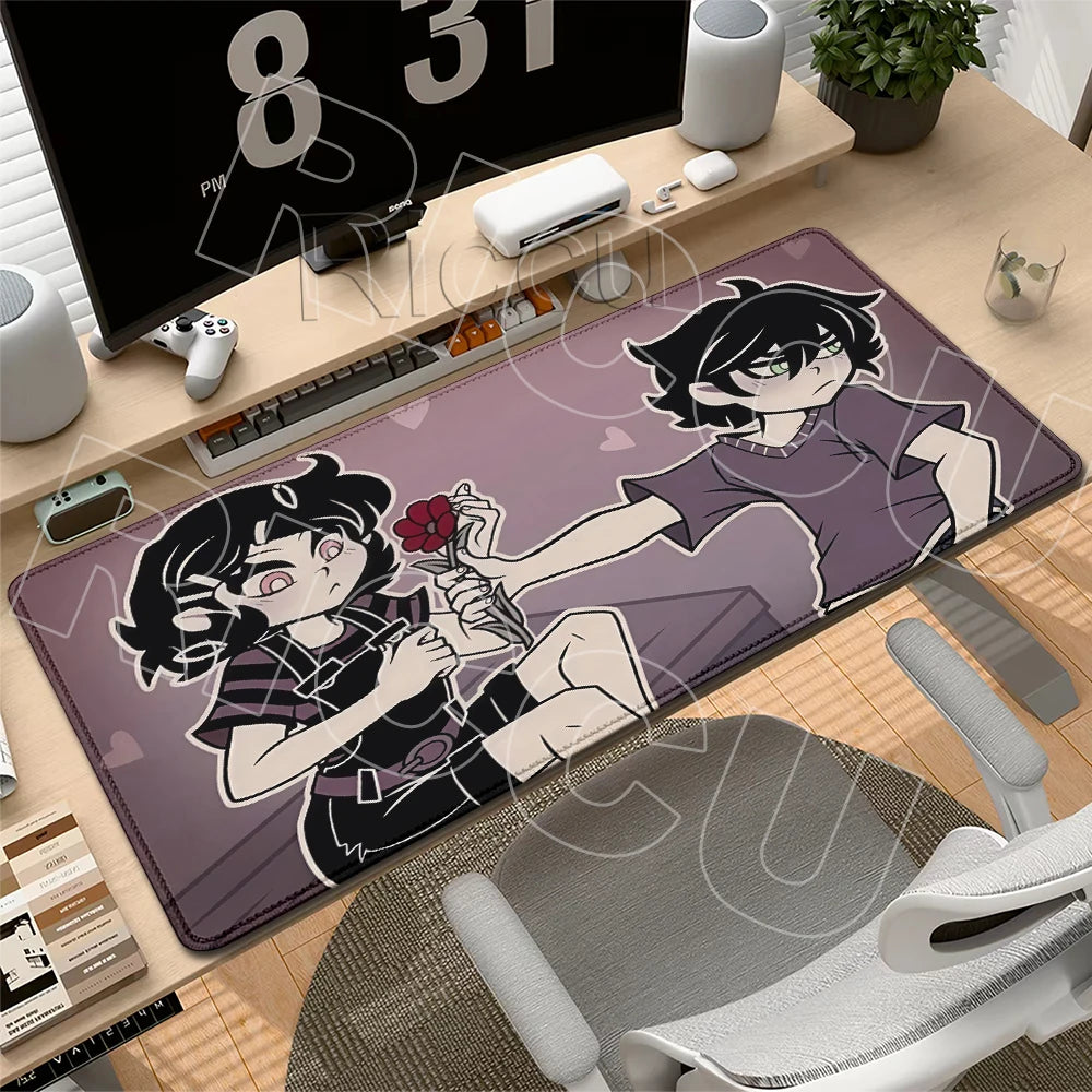 A gaming mouse pad featuring anime characters and a skull design placed on a wooden desk.