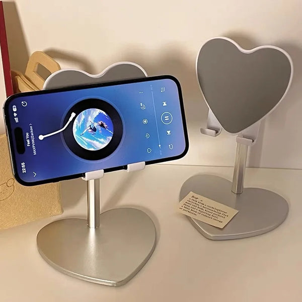 A silver adjustable desktop stand holding a smartphone displaying a map view of the Earth.