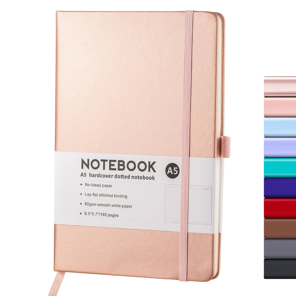 A pink hardcover notebook with a light pink elastic band and white text detailing its specifications.