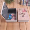 A mini dictionary safe is open, showing a dark compartment and a pink-themed book next to it.