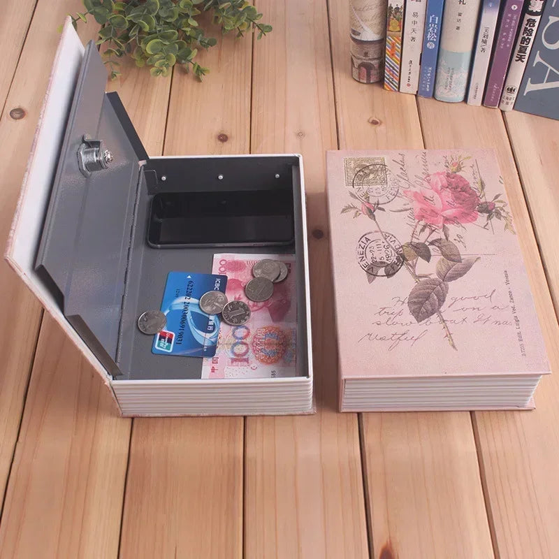 A mini dictionary safe is open, showing a dark compartment and a pink-themed book next to it.