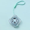 A clear plastic compact retractable measuring tape with a green cord is shown against a light blue background.