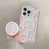 A clear floral magnetic phone case for an iPhone featuring pink blossoms and a circular cutout.