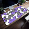 Purple and gray abstract wave design non-slip mouse pad placed on a wooden desk.