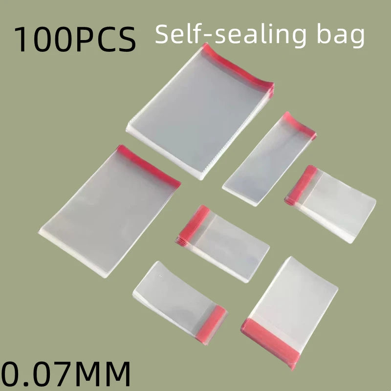 A collection of 100 self-sealing transparent plastic bags with pink edges arranged in a pyramid shape.