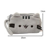 A light gray plush cat pencil case with black facial features and a loop for carrying.