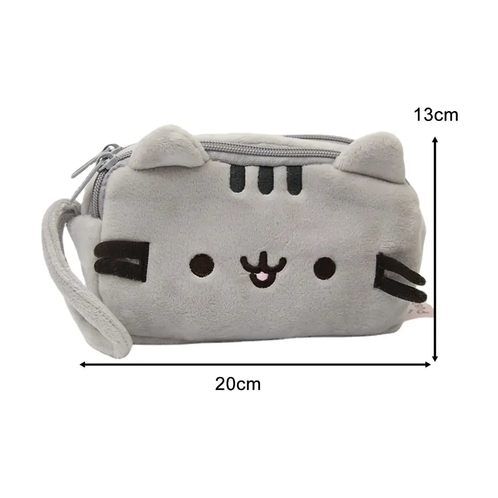 A light gray plush cat pencil case with black facial features and a loop for carrying.