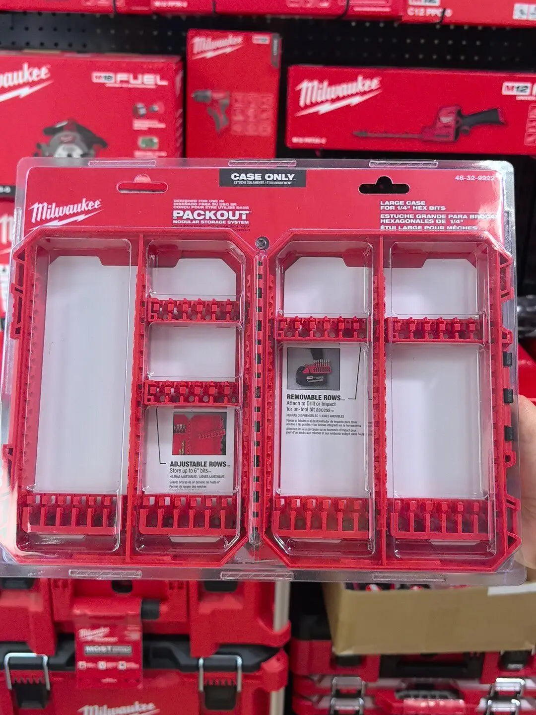 A red Milwaukee PACKOUT medium customizable bit storage case with multiple removable rows for tool bits.