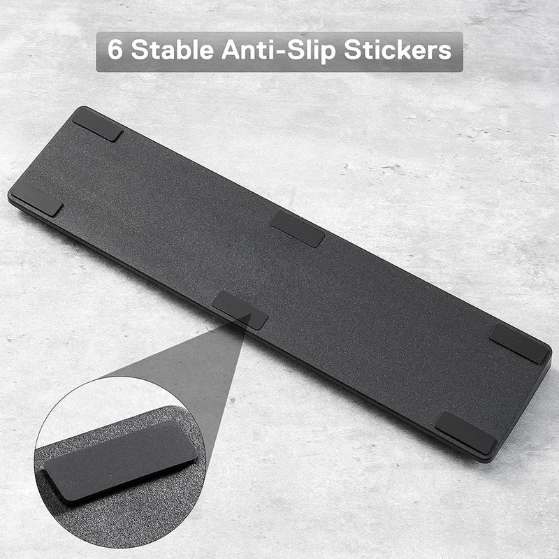 A black ergonomic memory foam keyboard wrist rest with an anti-slip base and six anti-slip stickers.