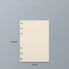 Un cuaderno de hojas sueltas rectangular, beige claro, con agujeros perforados en el borde izquierdo, sobre fondo gris.