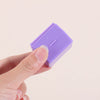 A hand holds a purple privacy protection roller stamp for confidential documents.