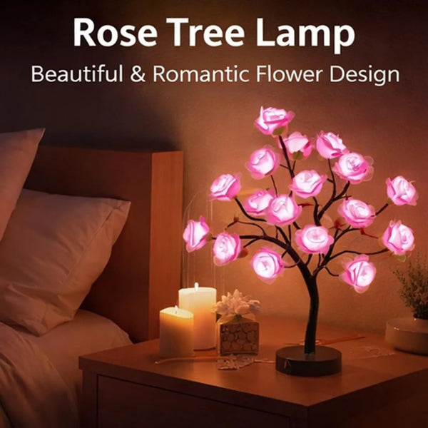 A Rose Tree lamp with pink glowing flowers illuminates a bedside table.