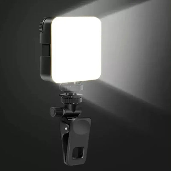 A small clip-on LED fill light with a bright white light emitting from the front.