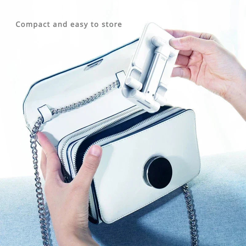 A hand is holding a white leather phone case with a built-in adjustable holder stand.