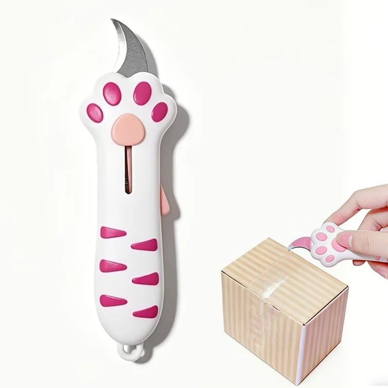 A white retractable utility knife shaped like a cat paw with pink accents, shown next to its packaging box.