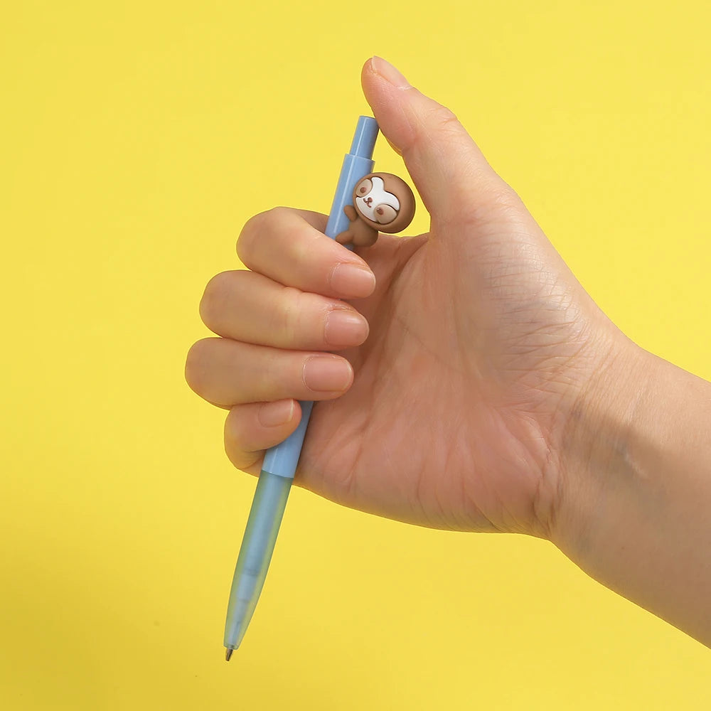 A hand holds a light blue mechanical pencil with a cute animal design, against a yellow background.