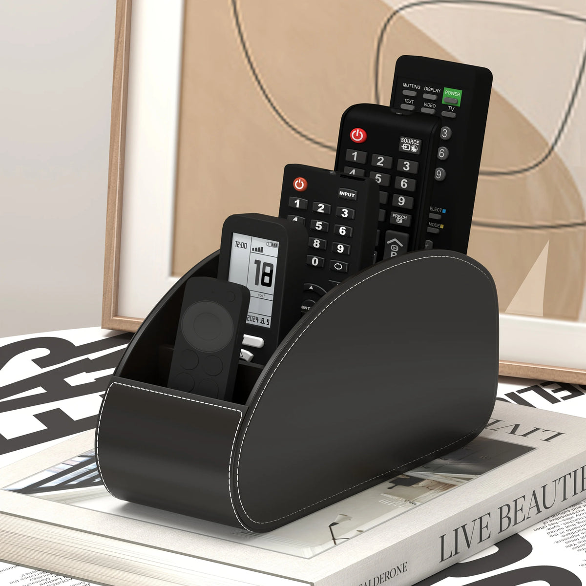 A black remote control holder and desk organizer tray displaying multiple black remote controls.