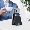 Une pochette de portefeuille en cuir noir magnétique pour iPhone, à côté d'une tasse blanche et d'une veste de costume bleue.