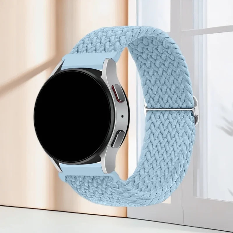 A light blue knitted nylon watch strap is shown next to a black smartwatch face.