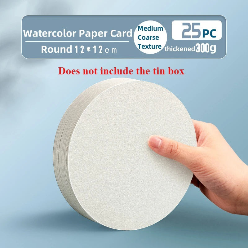 A hand holds a round white watercolor paper card, showing its texture and thickness.