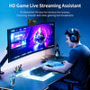 A man is using an HD Game Live Streaming Assistant setup with a monitor, keyboard, and headphones.