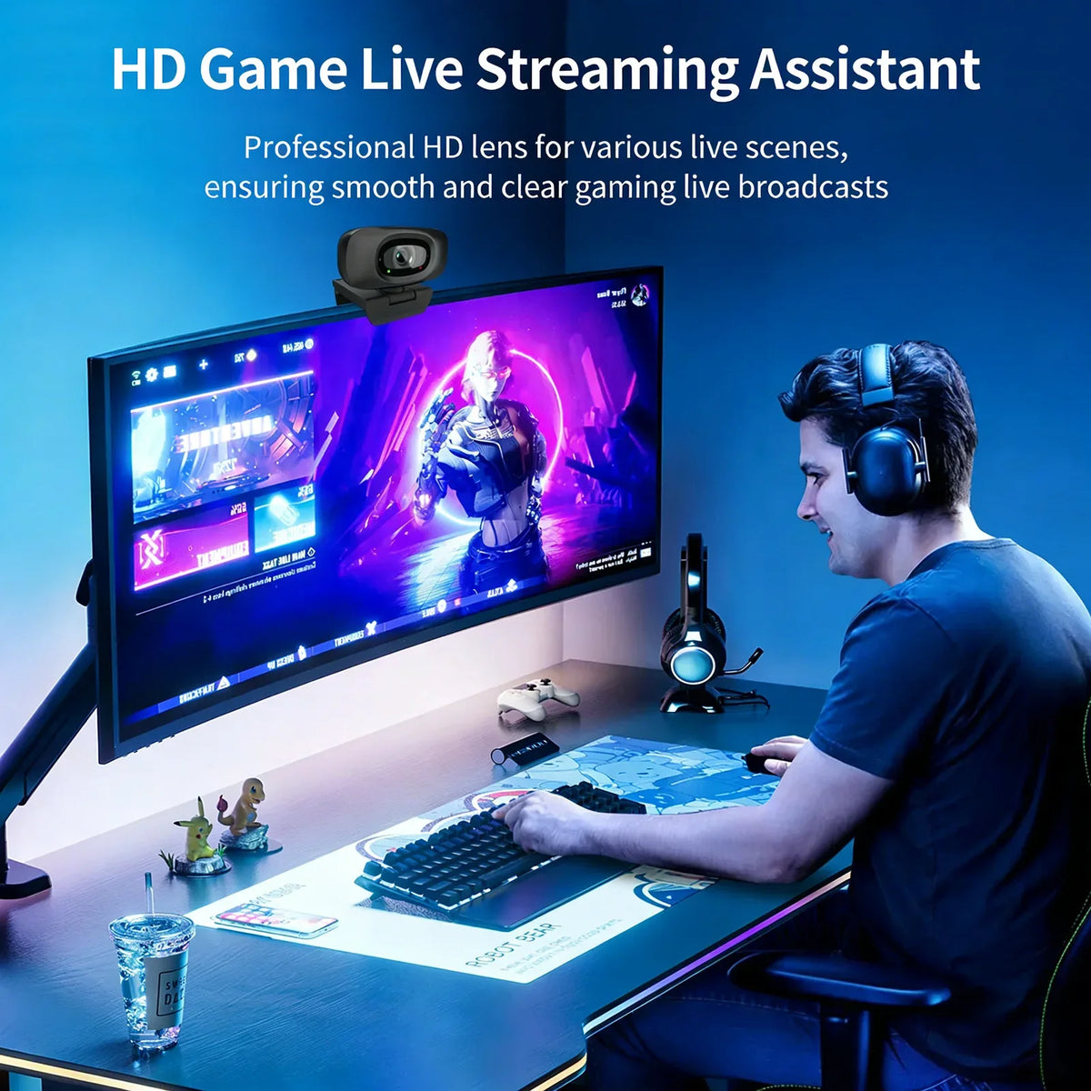 A man is using an HD Game Live Streaming Assistant setup with a monitor, keyboard, and headphones.