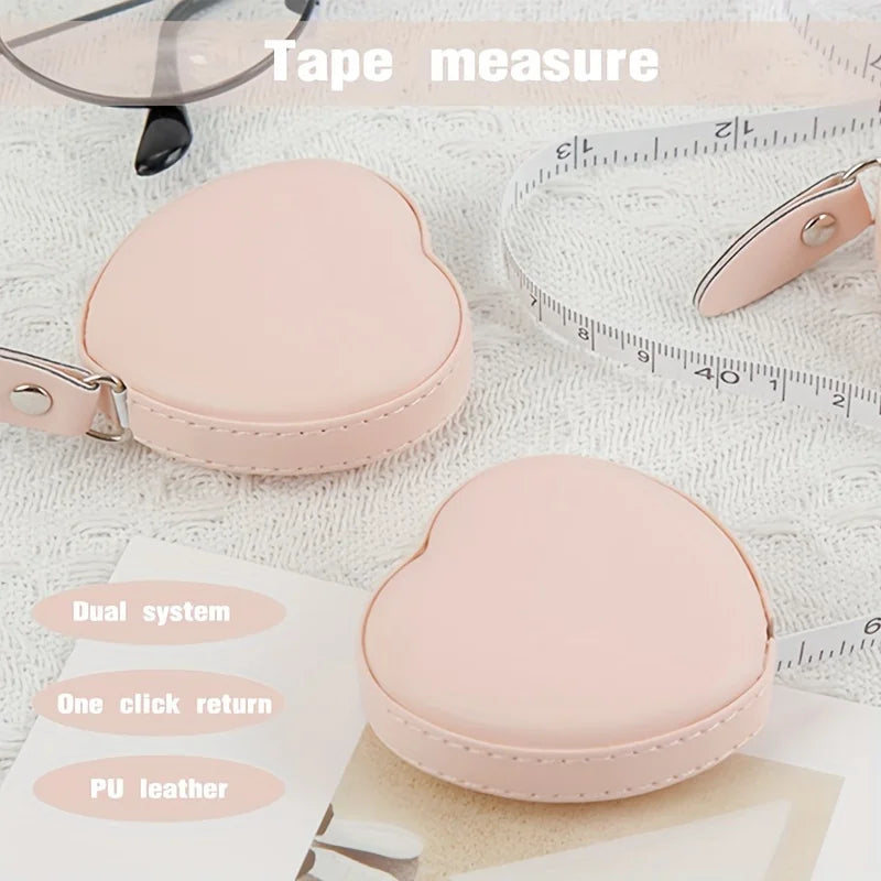 Pink PU leather measuring tape and a heart-shaped measuring tool with a clip.
