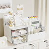 A white desk organizer with two clear storage drawers holds stationery, calendars, and office supplies.
