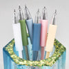 A set of six precision utility knives in various pastel colors displayed inside a blue glass container.