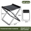 Taburete plegable portátil negro de material de acero espesado, con dimensiones y límite de peso.
