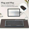 A black laptop is shown next to a keyboard and an adapter kit demonstrating plug and play functionality.