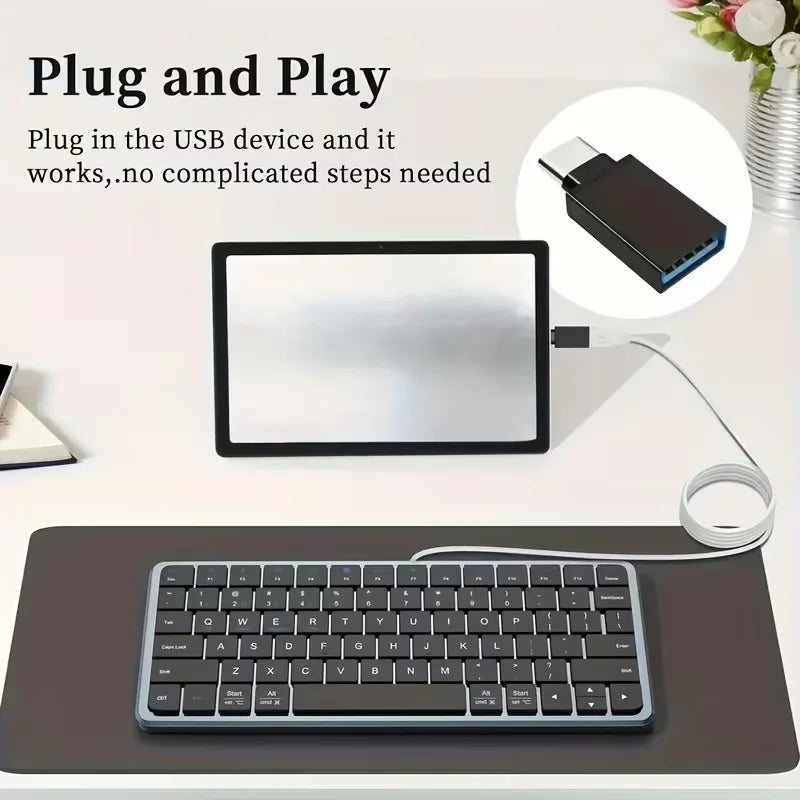 A black laptop is shown next to a keyboard and an adapter kit demonstrating plug and play functionality.