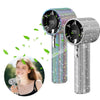 A silver mini portable LED turbine fan is shown next to a woman smiling and holding a small fan.