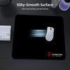 A black gaming mouse pad with a white mouse resting on it, featuring a silky-smooth surface.