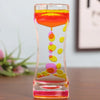 A glass hourglass filled with colorful liquid, demonstrating a time-based sensory experience.