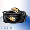 A coil of high-performance CAT8 Ethernet network cable with yellow connectors is shown on a blue surface.